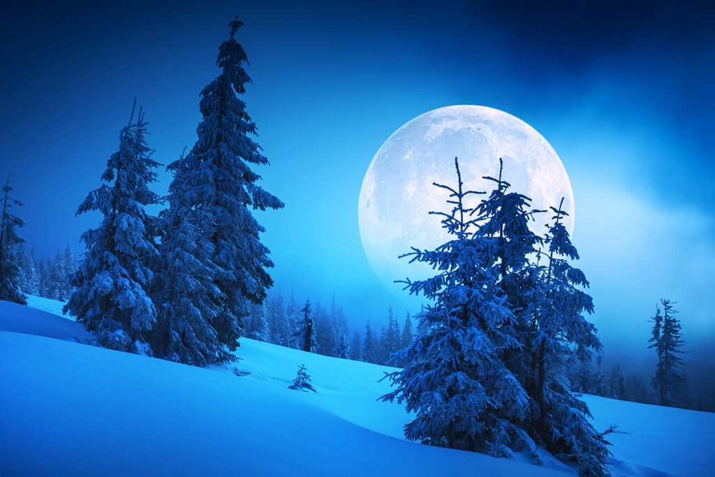 Moon over snowy mountains at night